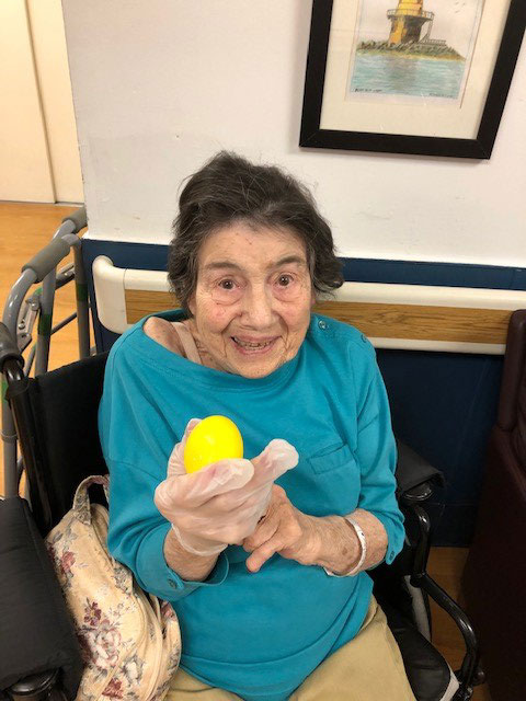 Resident holding a yellow easter egg
