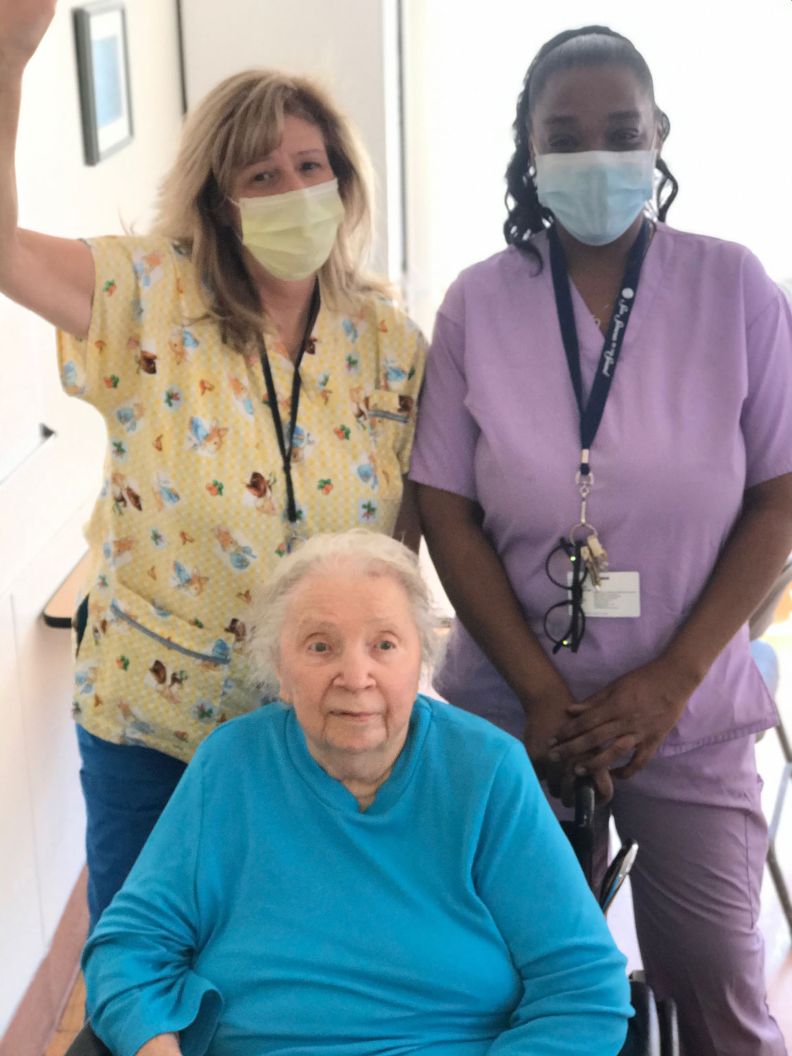 Two nurses sitting with a senior resident