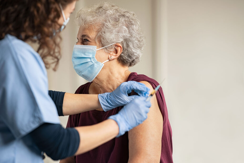 senior female receiving COVID vaccine