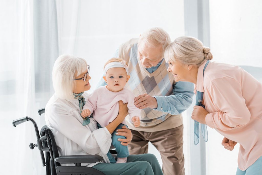 seniors holding a baby at a nursing home