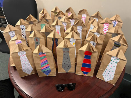 table of Father's Day gift bags with sunglasses