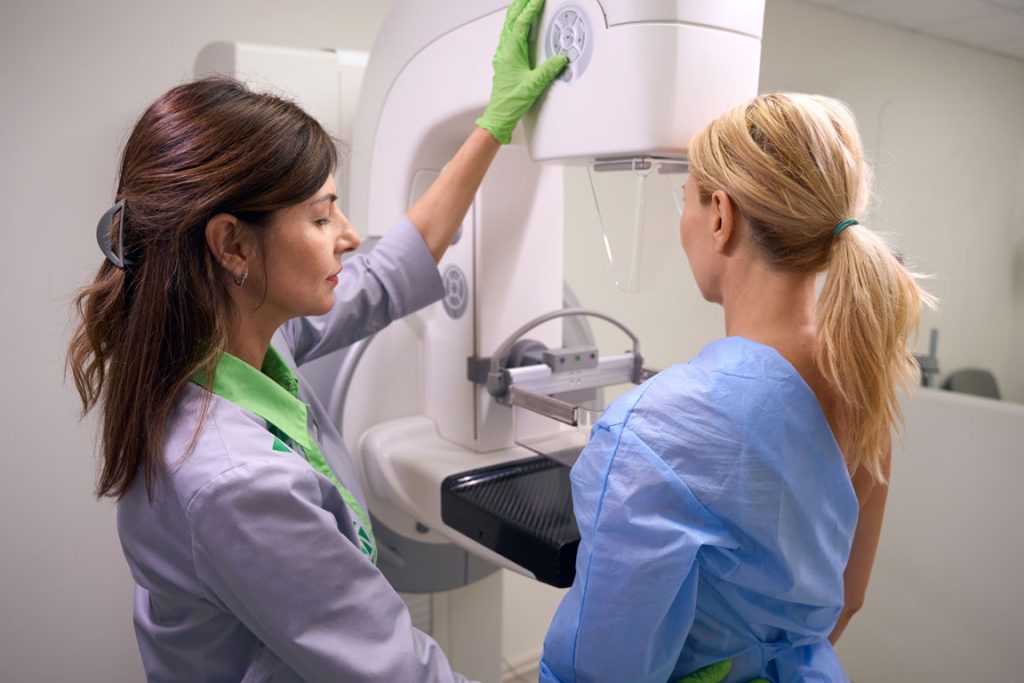 female doctor giving patient a mammogram